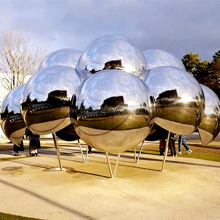 Public art installation large mirrored stainless steel sphere sculpture